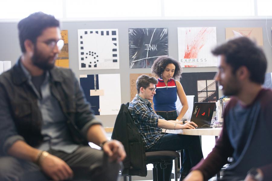 Instructor and student looking at a laptop.